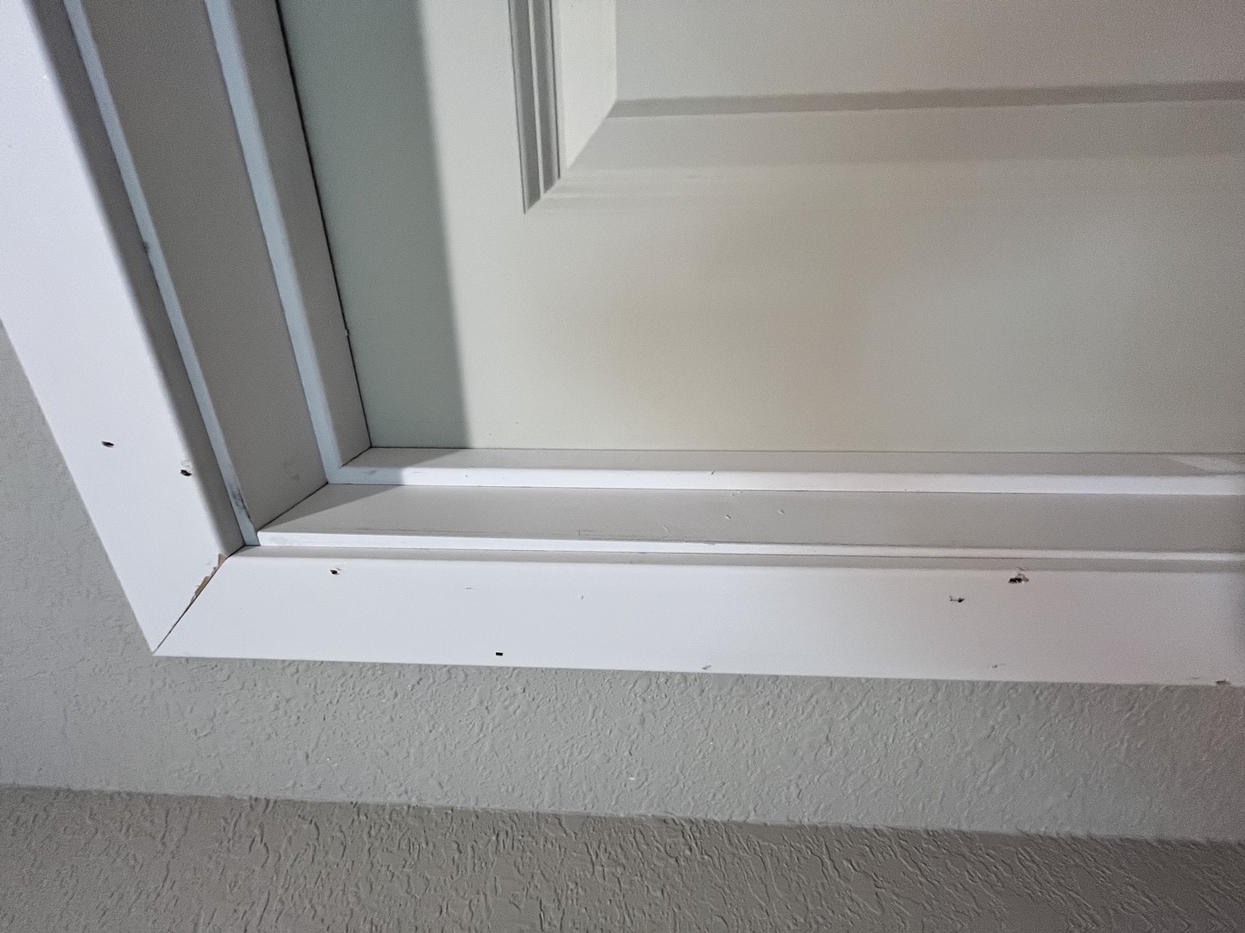 The same trim corner after touch-up painting, crisp white finish